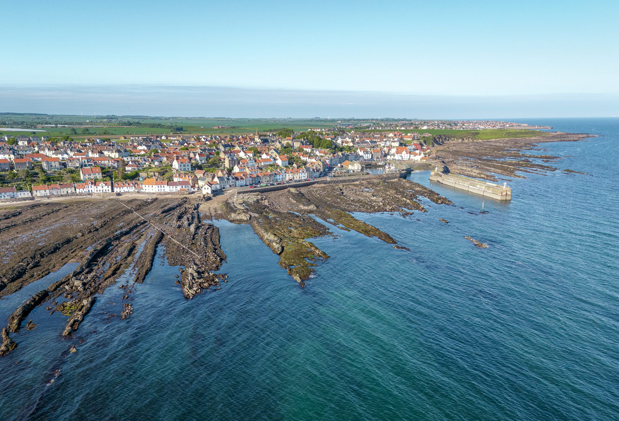 Pittenweem seen across the rocks at low tide